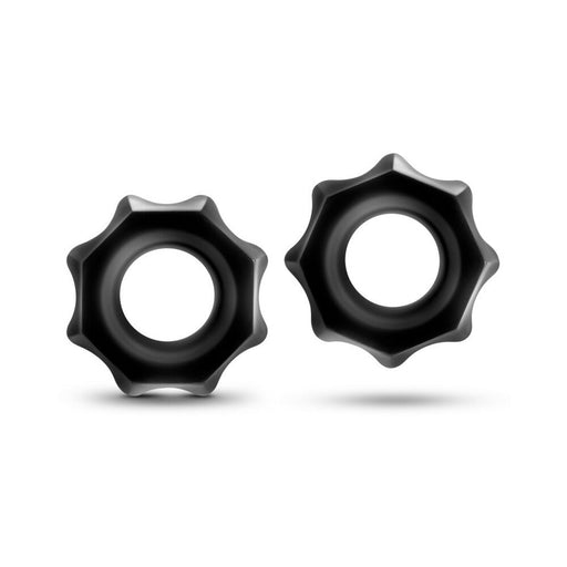 Two black Stay Hard Nutz cock rings with a textured, gear-like outer edge on a white background.
