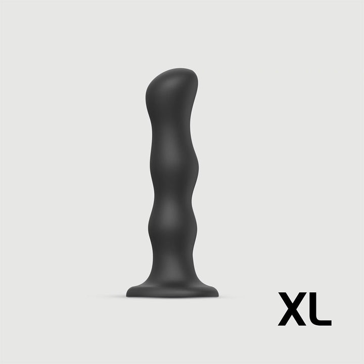 Black XL sized ergonomic dildo with suction base and contoured shape for versatile use.