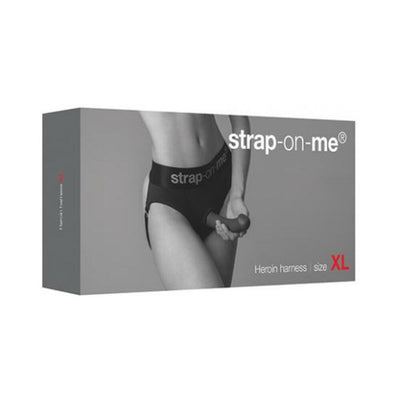 Packaging box of Strap-on-me Harness Lingerie Heroine in size XL featuring a model wearing the black harness.