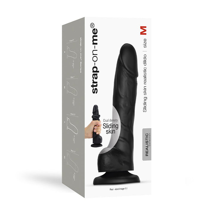 Black realistic dual-density dildo with sliding skin texture, size M, shown on product packaging with hand holding smaller version.