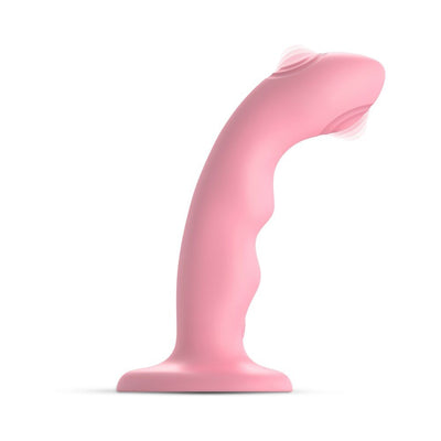 Pink curved silicone dildo with wavy design and double-tapping vibrating tip on a suction base.