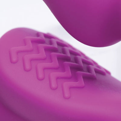 Close-up of textured pink silicone surface with raised zigzag pattern on a strapless vibrating dildo.
