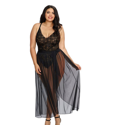 Plus size model wearing black stretch lace teddy with sheer mesh maxi skirt and adjustable straps, styled with black heels.