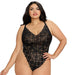 Plus size model wearing a black stretch lace teddy with floral pattern and adjustable straps against a white background.