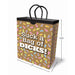Brown gift bag with colorful playful shapes and bold white text saying Suck a Bag of Dicks, with black woven handles and size dimensions shown.