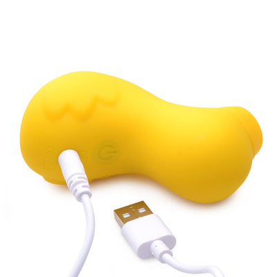 Yellow duck-shaped clitoral stimulator with USB charging cable on white background.