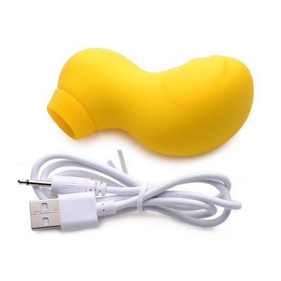 Yellow silicone clitoral stimulator with ergonomic shape and USB charging cable on white background.