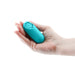 Teal mini bullet vibrator with flower-shaped control buttons held in a hand against a white background.