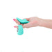 Hand holding teal Sugar Pop Leila panty vibrator and matching remote with control buttons on white background.