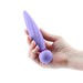 Hand holding a lavender silicone vibrator with a textured, twist design and rounded base with power button.