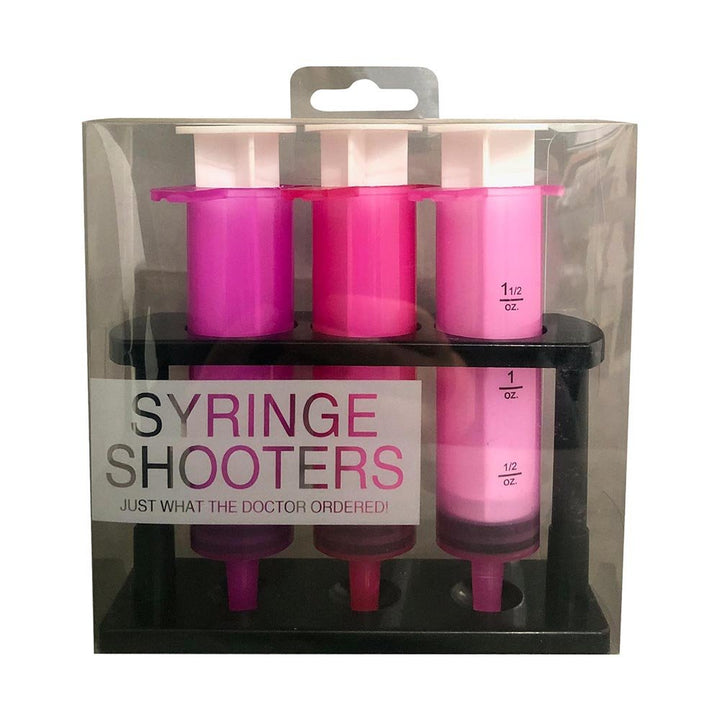 Set of three pink plastic syringe-shaped drink shooters in a black stand, packaged in clear box.