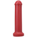 Red silicone mini toy inspired by Amsterdam traffic barriers with smooth cylindrical shape and rounded top.