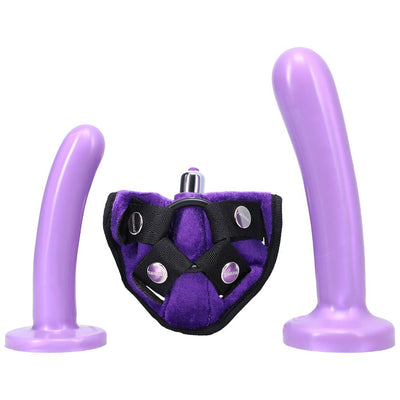 Purple strap-on harness kit with two silicone dildos and a small vibrating bullet, displayed on a white background.