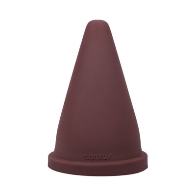 Oxblood red firm silicone cone-shaped adult toy with a wide base and Tantus logo embossed at the bottom.