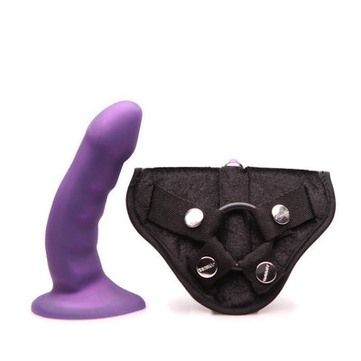 Midnight purple curved silicone dildo with adjustable black harness for strap-on use.
