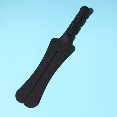 Black dual-tongue silicone paddle with textured handle on a light blue background.