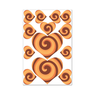 Sheet of heart-shaped edible pasties and wraps with cinnamon roll swirl design in shades of brown and orange.