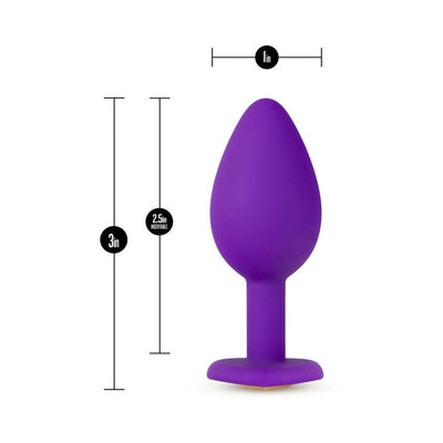 Small purple silicone tapered anal plug with flat base and gem detail, measuring 3 inches long and 1 inch wide.