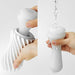 Hands demonstrating the flexible spiral design and rinsing of the Tenga Flex Bubbly Blue Stroker.