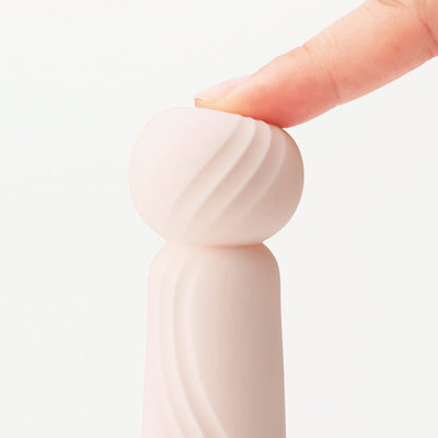 Close-up of Tenga Iroha Rin+ SANGO showing soft, textured spherical tip being gently pressed by a finger.