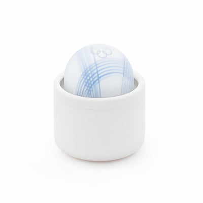 Compact white cylindrical device with a smooth, patterned blue and white spherical top in a minimalist design.