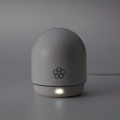 Compact white Tenga Iroha Temari Mizu device with a smooth rounded design and subtle flower logo on a neutral background.