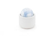 Compact white and blue Tenga Iroha Temari Mizu device with a smooth, rounded design in a white holder.