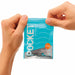 Hands holding a sealed blue package of Tenga Pocket Masturbator Sleeve Wavy Line with wave design and product details visible.