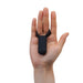 Hand holding a black Tenga Smart Vibrating Ring with a soft silicone design and compact shape.