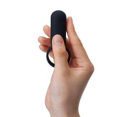 Hand holding a black silicone vibrating ring with a compact design and Tenga branding visible.