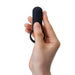 Hand holding a black silicone vibrating ring with a compact design and Tenga branding visible.