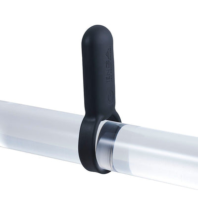 Black silicone vibrating ring displayed on a clear cylindrical rod, showing its stretchy and smooth design.