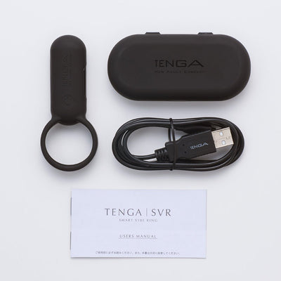 Tenga Smart Vibrating Ring with USB charging cable, black storage case, and user manual on white background.