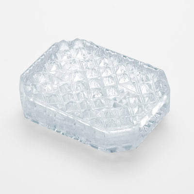 Clear textured Tenga Uni sleeve insert with raised pyramid pattern for enhanced sensation.