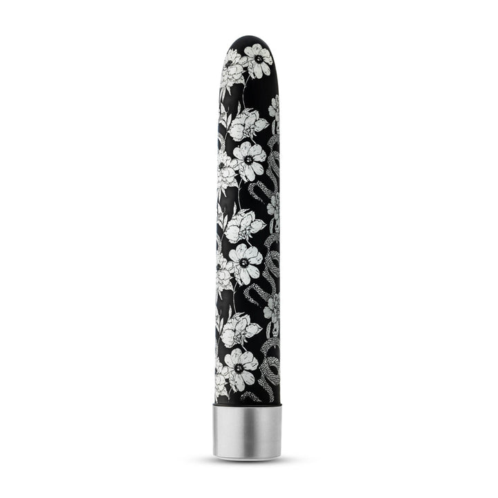 Black slimline vibrator with white floral and snake pattern and silver base, standing upright on white background.