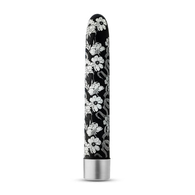 Black slimline vibrator with white floral and snake pattern and silver base, standing upright on white background.