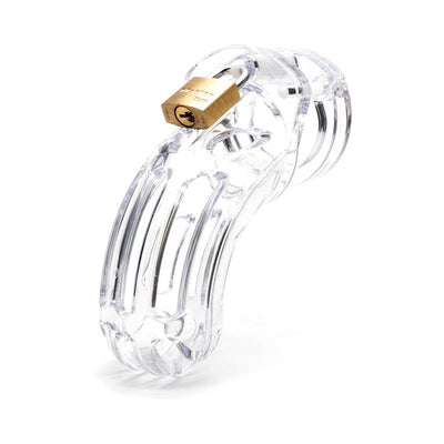 Clear medical-grade polycarbonate male chastity device with brass padlock on white background.