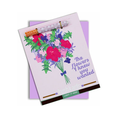 Greeting card with colorful floral illustration and attached metal one-hitter pipe featuring cannabis leaf design.