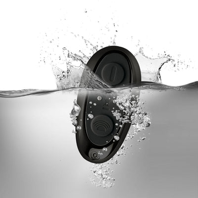 Black waterproof remote control with buttons submerged in water with splash and bubbles around it.
