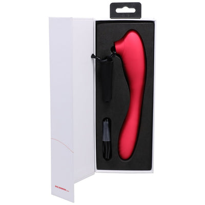 Red dual-ended silicone clitoral and G-spot stimulator in black foam packaging inside a white box.