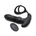 Black silicone thrusting vibrator with attached cock and ball ring and wireless remote control on white background.