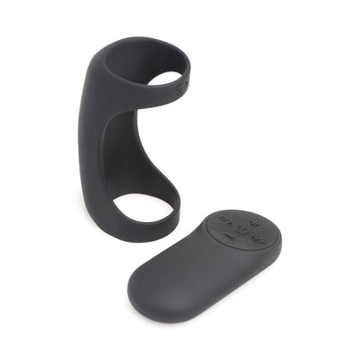 Black silicone vibrating shaft ring with matching remote control on white background.