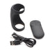Black silicone vibrating shaft ring with remote control and USB charging cable on white background