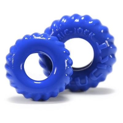Two blue textured silicone cockrings with a tire tread design, shown on a white background.