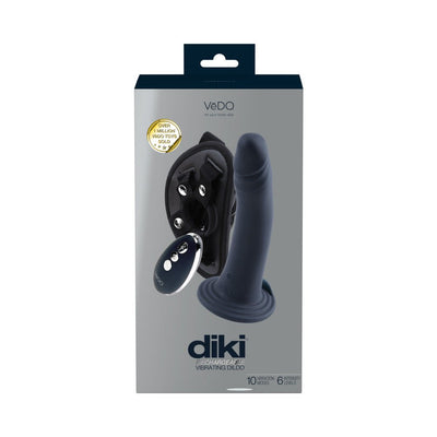 Packaging of Vedo Diki rechargeable vibrating dildo in black with adjustable harness and remote control shown on front.