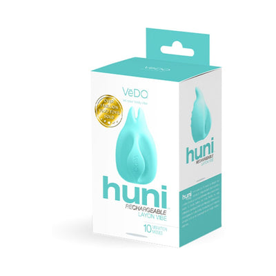 Vedo Huni rechargeable finger vibrator in turquoise with ergonomic design shown in retail packaging box.