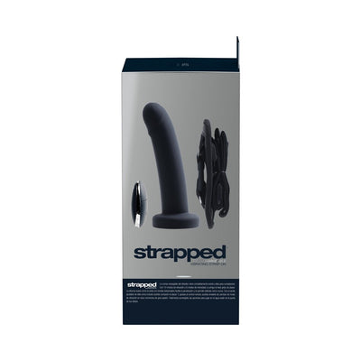 Packaging box of Vedo Strapped rechargeable black strap-on with remote control and adjustable harness shown on front.