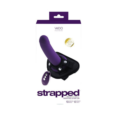 Deep purple rechargeable vibrating strap-on with adjustable black harness and remote control on white packaging.
