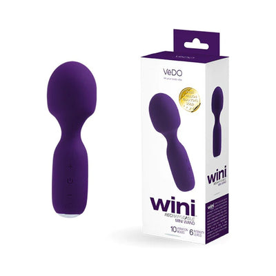 Purple Vedo Wini rechargeable mini wand with ergonomic handle and packaging showing product details.