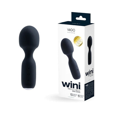 Compact black rechargeable mini wand with ergonomic handle next to its white and black packaging box.